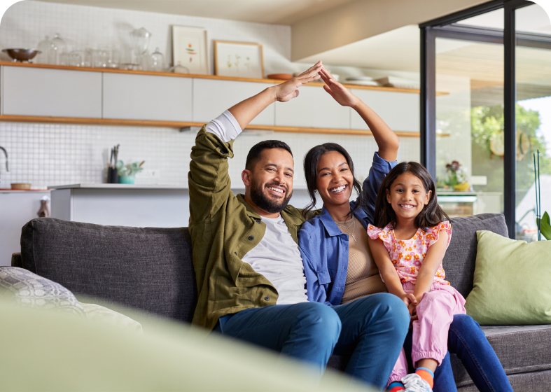 Parents and child smiling on couch