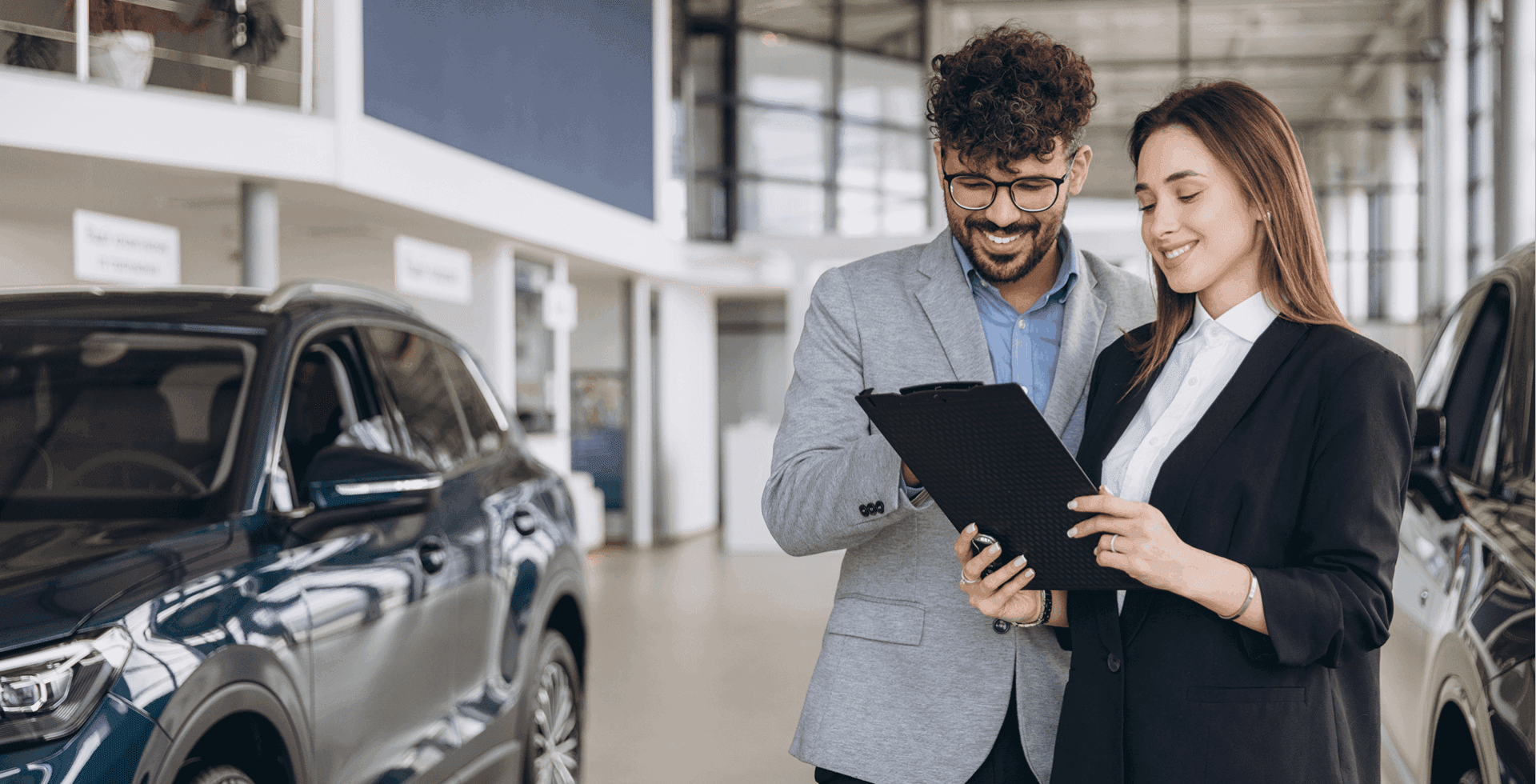 Salespeople reviewing documents in showroom