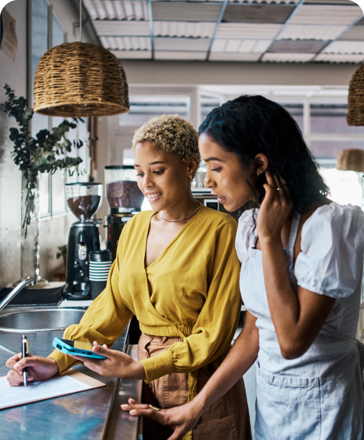 Women discussing work in a coffee shop